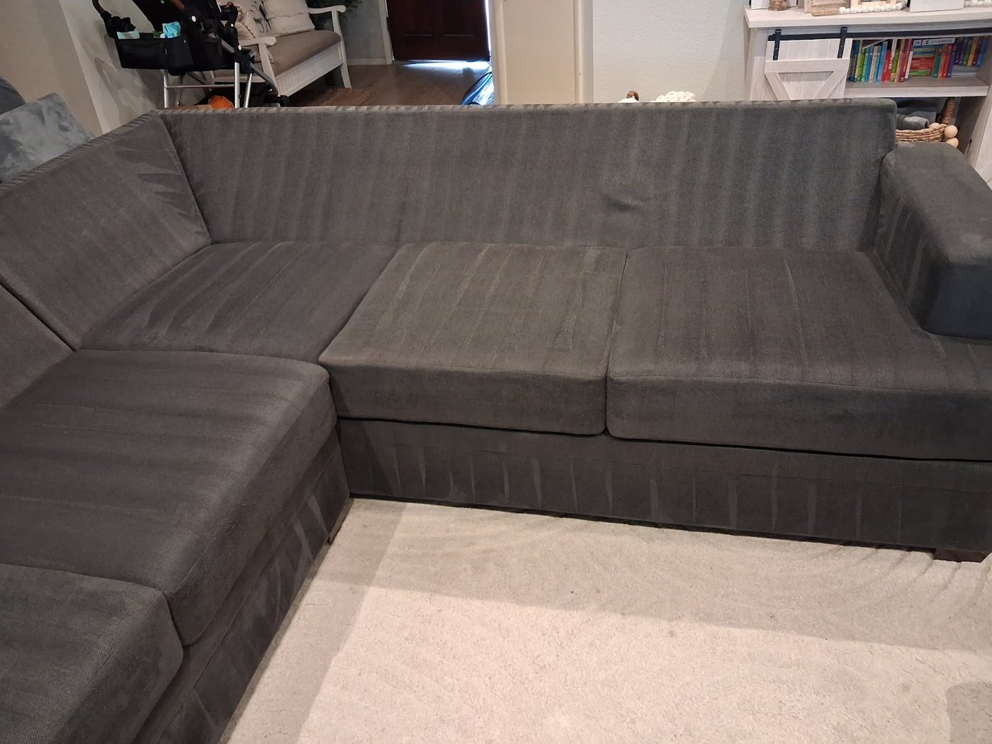 A gray sectional with fresh cleaning passes across the cushions